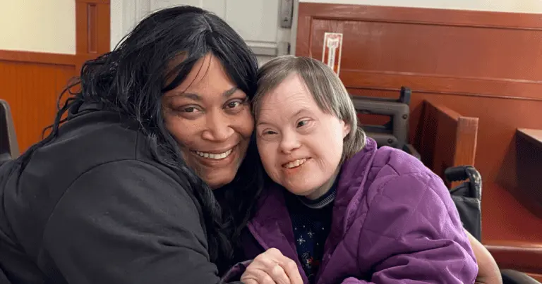 Intuitive Care caregiver smiling cheek-to-cheek with a client